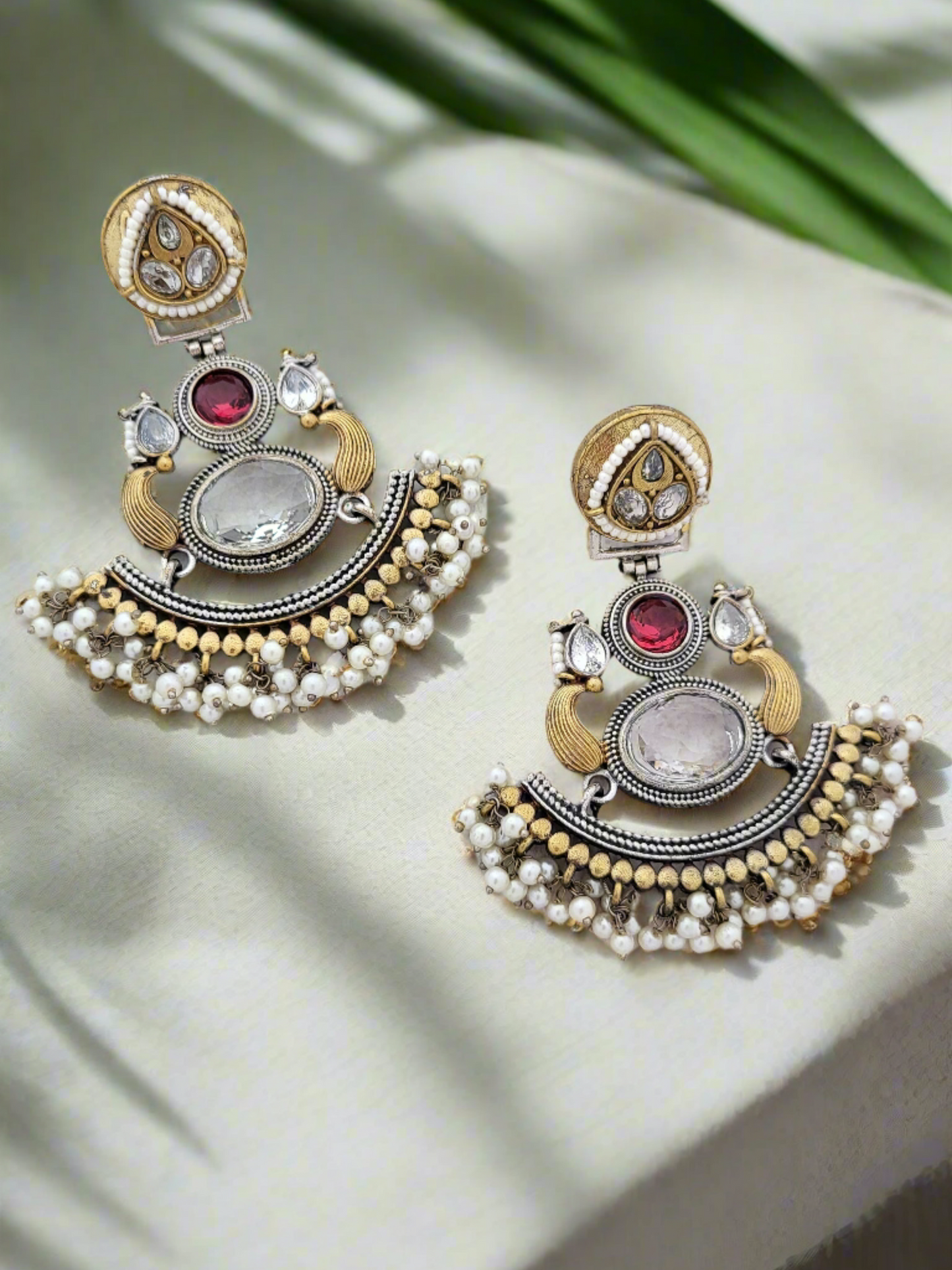 Two tone earrings with stone and pearl