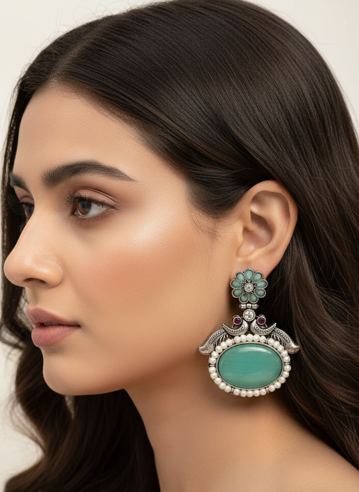 Oxidized Peacock motif earrings with big center stone